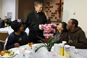 New Chicago archbishop greets guests during Thanksgiving dinner for homeless and hungry.