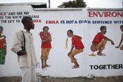 Liberian man looks at an Ebola sensitization campaign painted on a wall in downtown Monrovia.