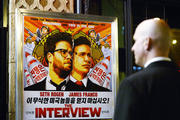 Security guard stands at United Artists theater during premiere of film 'The Interview' in Los Angeles