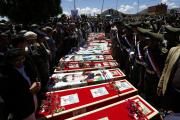 Yemeni mourners gather beside coffins of recent suicide attacks.