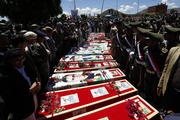 Yemeni mourners gather beside the coffins of the victims of recent suicide attacks during a funeral in Sana'a, Yemen, March 25. (CNS photo/Yahya Arhab, EPA) 