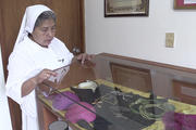 Carmelite Sister Maria Julia Garcia shows some of Archbishop Oscar Romero's relics at a museum in San Salvador. 
