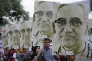People carry large portraits of Salvadoran Archbishop Oscar Romero during rally in his honor in San Salvador (CNS photo/Roberto Escobar, EPA)
