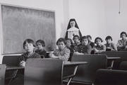 A 1940 photo shows indigenous students and a nun in a girls' classroom at Cross Lake Indian Residential School in Manitoba. (CNS photo/Library and Archives Canada, Reuters) 