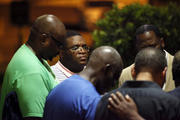 Prayer for Charleston. A prayer circle forms near the Emanuel AME Church as police began a hunt for a 21-year-old suspect on June 17.