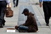 In this June 16, 2014, file photo, a homeless man sits on a sidewalk in New York City. (CNS photo/Justin Lane, EPA)