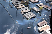 In this Sept. 10, 2005 file photo, homes are surrounded by floodwater and oil slicks in St. Bernard Parish in New Orleans, La. (CNS photo/Frank J. Methe, Clarion Herald) 