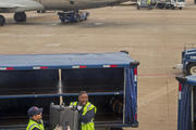 An American Airlines ground crew unloads baggage at Dallas/Fort Worth Airport in late March. Labor Day, honoring working people of America, is observed Sept. 7 this year. (CNS photo/Jim West)