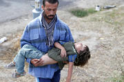 A migrant seeks medical attention for a child suffering with heatstroke in the village of Roszke, Hungary, Sept. 7. (CNS photo/Laszlo Balogh, Reuters) 