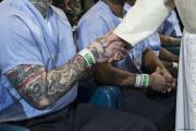 Pope Francis shakes hands with an inmate bearing a tatto at the Curran-Fromhold Correctional Facility in Philadelphia Sept. 27. (CNS photo/L'Osservatore Romano, handout) 