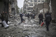 AFTERMATH. Survivors sift through the rubble of a destroyed field hospital in the rebel-held area of Douma on the outskirts of Damascus, on Oct. 29.