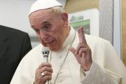 Pope Francis gestures as he answers questions from journalists aboard his flight from Bangui, Central African Republic, to Rome Nov. 30. (CNS photo/Paul Haring) 