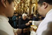  Chinese Catholics receive Communion in 2012 during Christmas Eve Mass in Beijing. A top Politburo official told faith leaders that religious groups must promote Chinese culture and become more compatible with socialism. (CNS photo/How Hwee Young, EPA) 