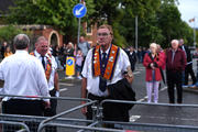 A member of the Orange Order looks on July 12, 2016, at a temporary blockade put in place by police during the order's annual parade in Belfast, Northern Ireland. Loyalists were commemorating the 1690 defeat of the Catholic King James II by the Protestant Prince William of Orange. (CNS photo/Clodagh Kilcoyne, Reuters)
