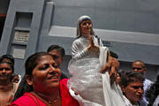 A woman holds a statuette of Mother Teresa outside the Missionaries of Charity building in Kolkata, India, Sept. 4. (CNS photo/Rupak De Chowdhuri, Reuters)