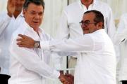 Colombian President Juan Manuel Santos and Marxist rebel leader Rodrigo Londono Echeverri of FARC, the Revolutionary Armed Forces of Colombia, shake hands Sept. 26 in Bogota. (CNS photo/John Vizcaino, Reuters)