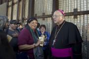 San Diego Bishop Robert W. McElroy speaks with people at the U.S.-Mexico border fence in San Diego during the 23rd Posada Sin Fronteras (Posada Without Borders) on Dec. 10, 2016. (CNS photo/David Maung)