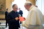 Pope Francis accepts an issue of La Civilta Cattolica from Father Antonio Spadaro, editor of the Jesuit-run magazine, during a Feb. 9 meeting with editors and staff. (CNS photo/L'Osservatore Romano, handout) 