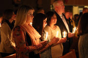 Worshippers hold candles at the beginning of the Easter Vigil at St. Louis de Montfort Church in Sound Beach, N.Y., in April 2017. (CNS photo/Gregory A. Shemitz)