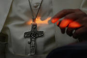 A shaft of light illuminates Pope Francis during his press conference while returning from Ireland. (CNS photo/Paul Haring)