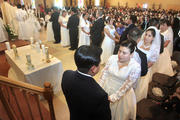 Couples exchange vows during a wedding service at St. Michael the Archangel Church in Georgetown, Del., on Feb. 14, 2010. (CNS photo/Don Blake, The Dialog)