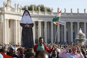 A man holds a life-size cutout of new St. Mariam Thresia Chiramel Mankidiyan of India before the canonization Mass for five new saints celebrated by Pope Francis in St. Peter's Square at the Vatican on Oct. 13. (CNS photo/Paul Haring)