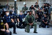 Police officers in Atlanta kneel with protesters on June 1, following a white police officer’s killing of George Floyd, an African American, in Minneapolis on May 25. (CNS photo/Dustin Chambers, Reuters)