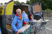 In August volunteers unload a van of food donations to a local food bank in the town of Penicuik, in Midlothian, Scotland. iStock