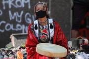 A young woman takes part in a rally in Toronto June 6, 2021, after the remains of 215 children were on the grounds of the Kamloops Indian Residential School in May. For years Indigenous people in Canada have wanted an apology from the pope for the church's role in abuse at Catholic-run residential schools. (CNS photo/Chris Helgren, Reuters)