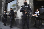 Heavily armed police guard the streets in down town San Salvador, El Salvador, on March 27. El Salvador's congress has granted President Nayib Bukele request to declare a state of emergency, after a wave of gang-related killings. (AP Photo/Salvador Melendez)