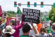 A participant in the fourth annual Virginia March for Life in Richmond, Va., on April 27, 2022, carries a sign in Spanish reading "Pray for an end to abortion." (CNS photo/Michael Mickle, The Catholic Virginian)