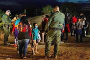 Jefferson, an 8-year old boy from Honduras, is questioned by a border patrol agent on Aug. 26 after crossing the Rio Grande into Roma, Texas.(CNS photo/Adrees Latif, Reuters)