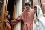 Juan Billarruem and Maria Bonilla play the part of Joseph and Mary seeking refuge on the night of Christ's birth during a posada at Holy Redeemer Parish in Detroit, Mich., on Dec. 19, 2001. (CNS photo by Audrey Sommers, Michigan Catholic) 