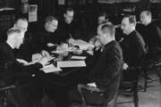 men sitting around a table editing the america magazine, circa 1950