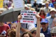 A woman holds up a sign during a rally against assisted suicide in 2016 on Parliament Hill in Ottawa, Ontario. In a Toronto speech, Cardinal Gerhard Muller, prefect of the Congregation for the Doctrine of the Faith, has urged Canadians to work to reverse euthanasia rulings. (CNS photo/Art Babych)