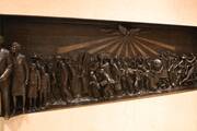 a bas relief sculpture of black people from slavery to emancipation with holy spirit above them