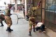 Election violence in 2018: Soldiers beat a female supporter of the opposition Movement for Democratic Change party of Nelson Chamisa outside the party's headquarters as they await the results of the general elections in August 2018 in Harare, Zimbabwe. (CNS photo/Mike Hutchings, Reuters) 