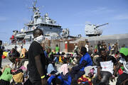 Migrants wait to be transferred from Lampedusa Island, Italy, on Sept. 15. Thousands of migrants and refugees have landed on the Italian island of Lampedusa this week after crossing the Mediterranean Sea on small unseaworthy boats from Tunisia, overwhelming local authorities and aid organizations. (AP Photo/Valeria Ferraro)
