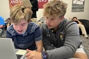 Special needs student Peter Marvin, a freshman, completes an assignment with the assistance of Landon Lewis, a senior and one of his peer mentors, at DeSmet Jesuit High School in St. Louis on Sept. 6, 2023 