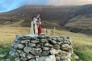 Father Gerard Quirke raises the chalice at Mass Rock overlooking Keem Bay on Ireland's Achill Island April 4, 2021. The church in Ireland is launching a Year for Vocations as it grapples with a steep decline in seminary numbers and with aging priests. (OSV News photo/Seán Molloy, courtesy Irish Catholic)