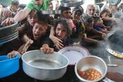 Young Palestinians gather to receive food cooked by a charity kitchen, amid the Israel-Hamas conflict, in the northern Gaza Strip Sept. 11, 2024. (OSV News photo/Mahmoud Issa, Reuters)