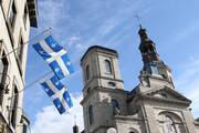 Quebec provincial flags are displayed outside a building across the street from the Cathedral-Basilica of Notre-Dame de Quebec in Quebec City Oct. 5, 2017. (CNS photo/Gregory A. Shemitz)