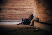Homeless man playing guitar in underpass tunnel (iStock/South_agency)