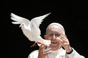 Pope Francis releases a dove outside the Basilica of St. Nicholas after meeting with the leaders of Christian churches in Bari, Italy, July 7. The pope met Christian leaders for an ecumenical day of prayer for peace in the Middle East. Pope Francis, formerly Argentine Cardinal Jorge Mario Bergoglio, died April 21, 2025, at age 88. (CNS photo/Paul Haring)