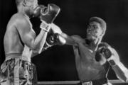 Muhammad Ali (Cassius Clay), right, lands on Don Warner's jaw in an early exchange of their fight in Miami Beach, Fla., Feb. 28, 1962 (AP Photo).