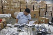 Claudio Montes checks a shipping manifest for U.S. manufactured parts heading to assembly plants in Mexico at Freight Dispatch Service Agency LTD in Pharr, Texas in June 2017. The freight service ships parts between the U.S. and Mexico that pass through the border freely due to the North American Free Trade Agreement. (Nathan Lambrecht/The Monitor via AP, File)