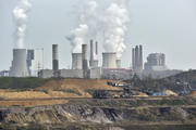Giant machines dig for brown coal at the open-cast mining Garzweiler in front of a power plant near the city of Grevenbroich in western Germany in April 2014. (AP Photo/Martin Meissner, File)