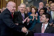Speaker of the House Paul Ryan, R-Wis., right, shakes hands after presenting a pen to House Ways and Means Committee Chairman Kevin Brady, R-Texas, left, as Senate Majority Leader Mitch McConnell, R-Ky., second from left, watches after signing the final version of the GOP tax bill during an enrollment ceremony at the Capitol in Washington, Thursday, Dec. 21, 2017. (AP Photo/Andrew Harnik)