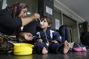 A migrant women from Iraq feeds her grandson in front of the railway station in Sarajevo, Bosnia, on June 19, 2018. Some hundreds of migrants have been camping at the railway station in the Bosnian capital of Sarajevo waiting for an opportunity to get to Croatia and Western Europe. (AP Photo/Amel Emric)