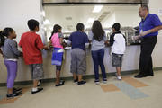 Detained immigrant children line up in the cafeteria in this Sept. 10, 2014 file photo at the Karnes County Residential Center, a detention center for immigrant families operated by the GEO Group in Karnes City, Texas. (AP Photo/Eric Gay, File)